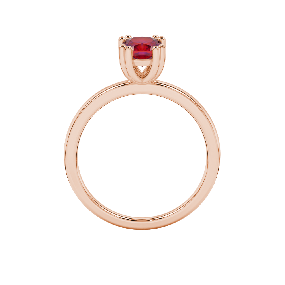 Red cushion cut solitaire gemstone ring in six-prong gold setting with slim stackable band