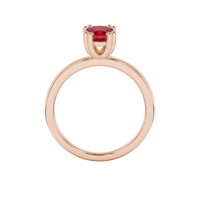 Red cushion cut solitaire gemstone ring in six-prong gold setting with slim stackable band