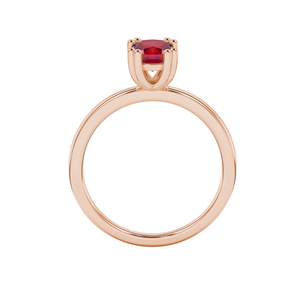 Red cushion cut solitaire gemstone ring in six-prong gold setting with slim stackable band