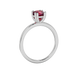 Red cushion cut solitaire gemstone ring in six-prong gold setting with slim stackable band