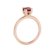 Red cushion cut solitaire gemstone ring in six-prong gold setting with slim stackable band