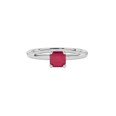 close-up of a radiant raspberry red gemstone enclosed in a white gold four-prong ring setting.