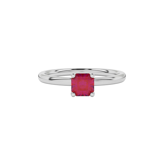 close-up of a radiant raspberry red gemstone enclosed in a white gold four-prong ring setting.