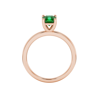 Radiant-cut emerald green gemstone solitaire ring in a rose gold classic basket setting.