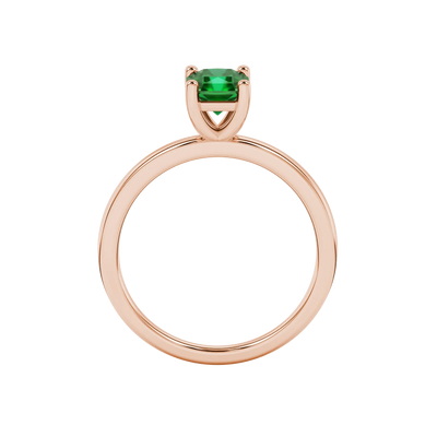 Radiant-cut emerald green gemstone solitaire ring in a rose gold classic basket setting.