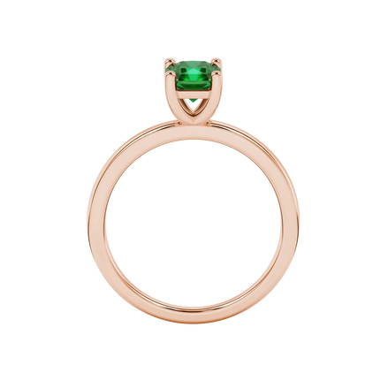 Radiant-cut emerald green gemstone solitaire ring in a rose gold classic basket setting.