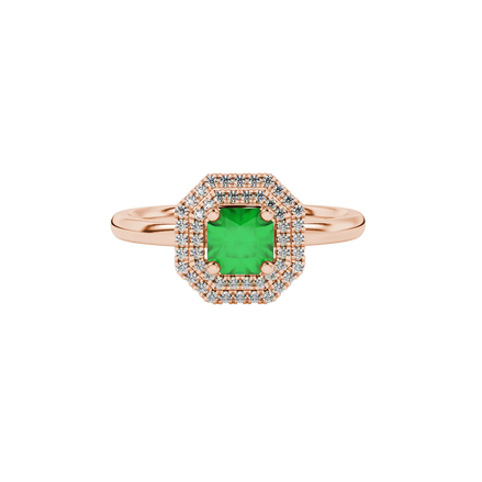 close-up shot of a radiant emerald green gemstone ring with a rose gold halo gallery.