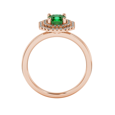 Radiant-cut emerald green gemstone solitaire ring in a rose gold falling edge halo setting.