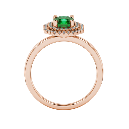 Radiant-cut emerald green gemstone solitaire ring in a rose gold falling edge halo setting.