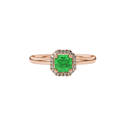 close-up shot of a radiant emerald green gemstone ring with a rose gold french pavé halo gallery.