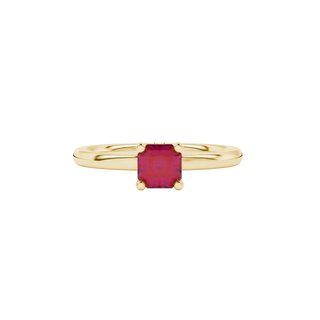 Close-up details of a radiant-cut raspberry red gemstone in a yellow gold lotus basket ring.