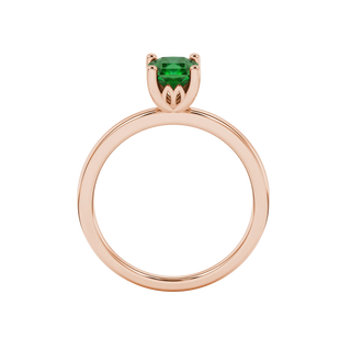 Radiant-cut emerald green gemstone solitaire ring in a rose gold lotus basket setting