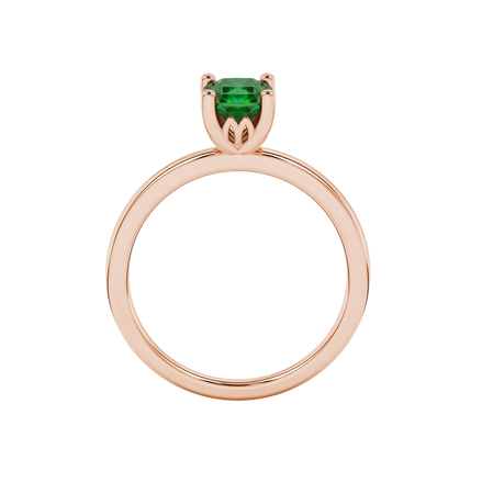Radiant-cut emerald green gemstone solitaire ring in a rose gold lotus basket setting