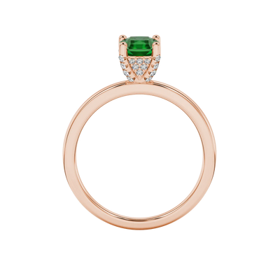 Radiant-cut emerald green gemstone solitaire ring in a rose gold pavé basket setting.