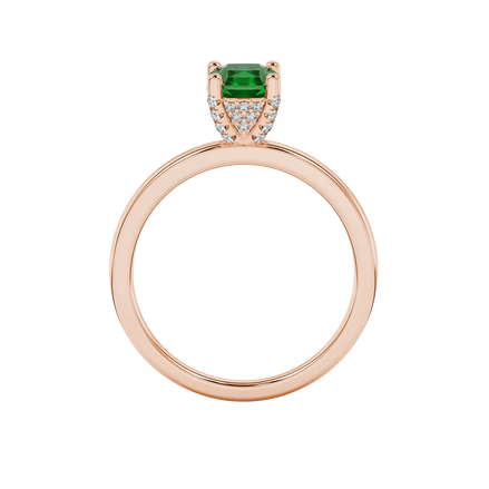 Radiant-cut emerald green gemstone solitaire ring in a rose gold pavé basket setting.