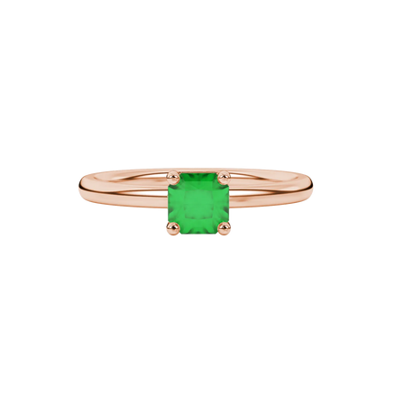 close-up shot of a radiant emerald green gemstone ring with a rose gold pavé basket gallery