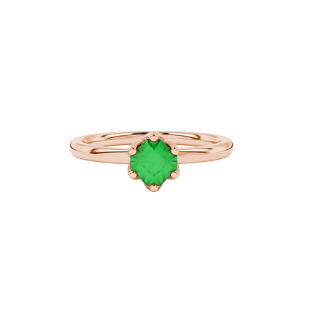 close-up shot of a radiant emerald green gemstone ring with a rose gold scalloped six-prong design.