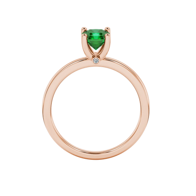 Radiant-cut emerald green gemstone solitaire ring in a rose gold surprise sapphire setting
