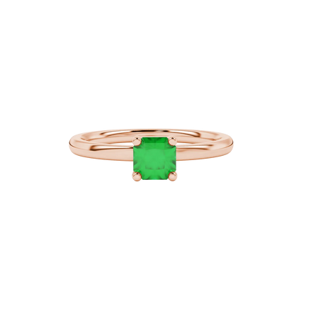 close-up shot of a radiant emerald green gemstone ring with a rose gold surprise sapphire accent.