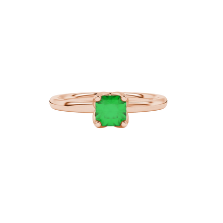 close-up shot of a radiant emerald green gemstone ring with a rose gold tulip basket gallery.
