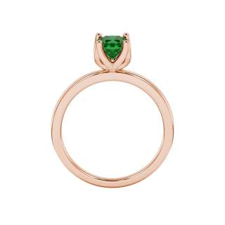 Radiant-cut emerald green gemstone solitaire ring in a rose gold tulip basket setting.