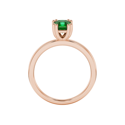 Radiant-cut emerald green gemstone solitaire ring in a rose gold vintage basket setting.