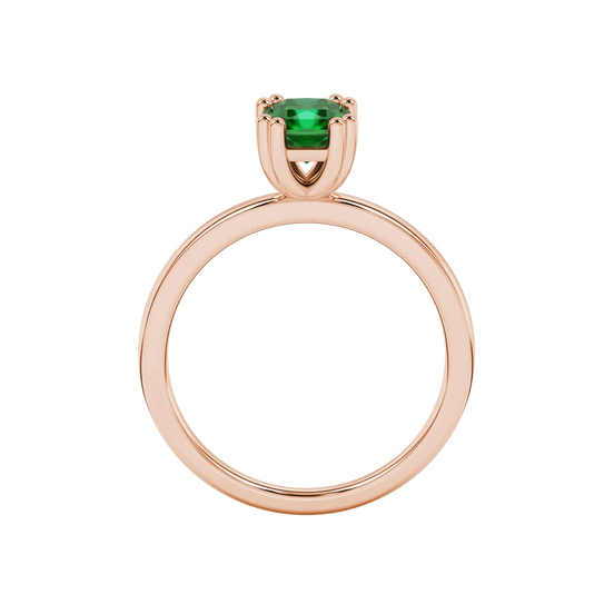 Radiant-cut emerald green gemstone solitaire ring in a rose gold vintage basket setting.