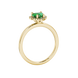 Side view of Emerald Green heart cut gemstone halo ring in yellow gold
