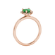 Side view of Emerald Green heart cut gemstone halo ring in rose gold
