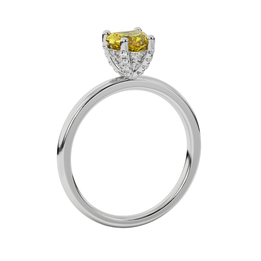 Side angle of a white gold heart gemstone ring displaying the sparkling diamond pavé basket gallery.