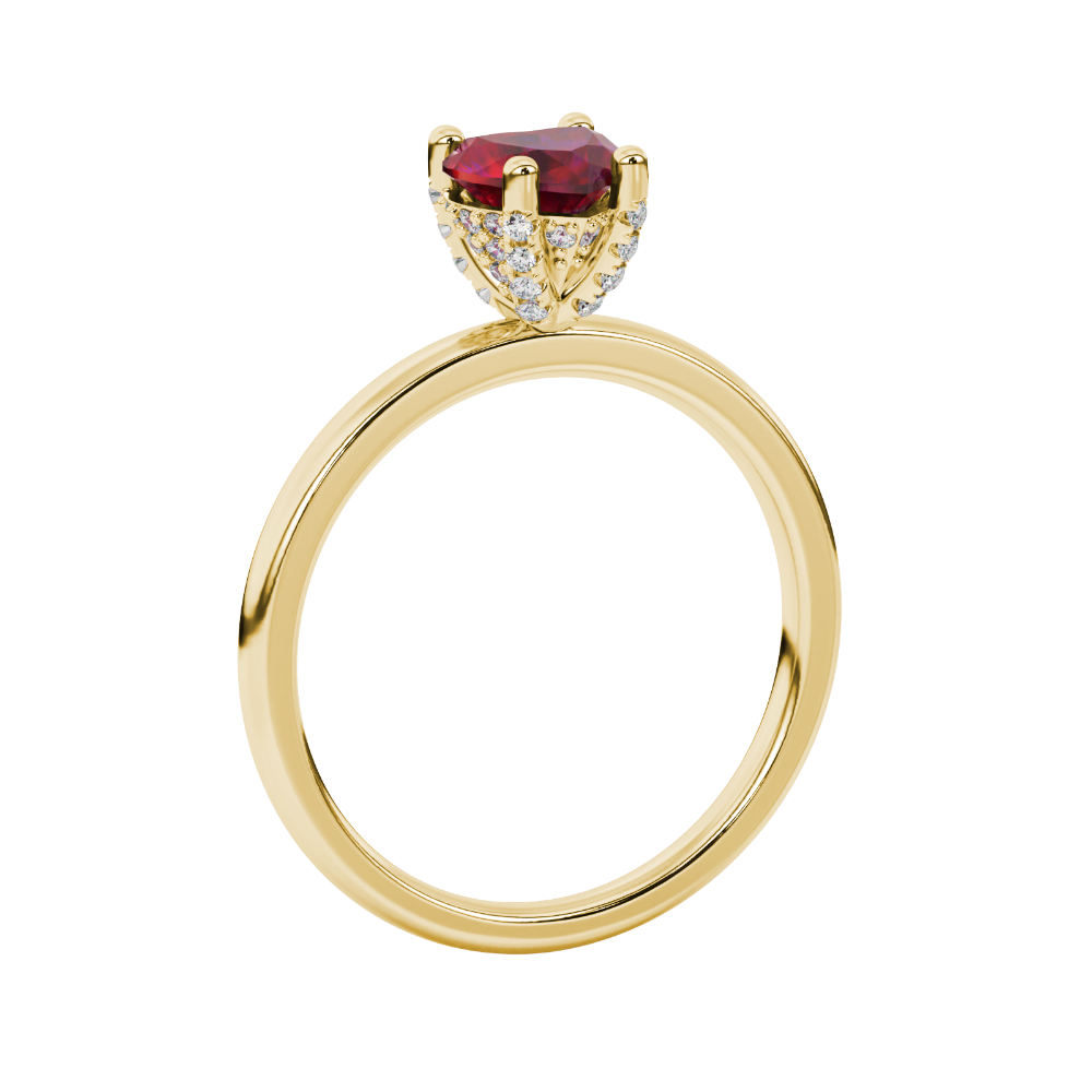 Side angle of a yellow gold heart gemstone ring highlighting the brilliant diamond pavé basket.