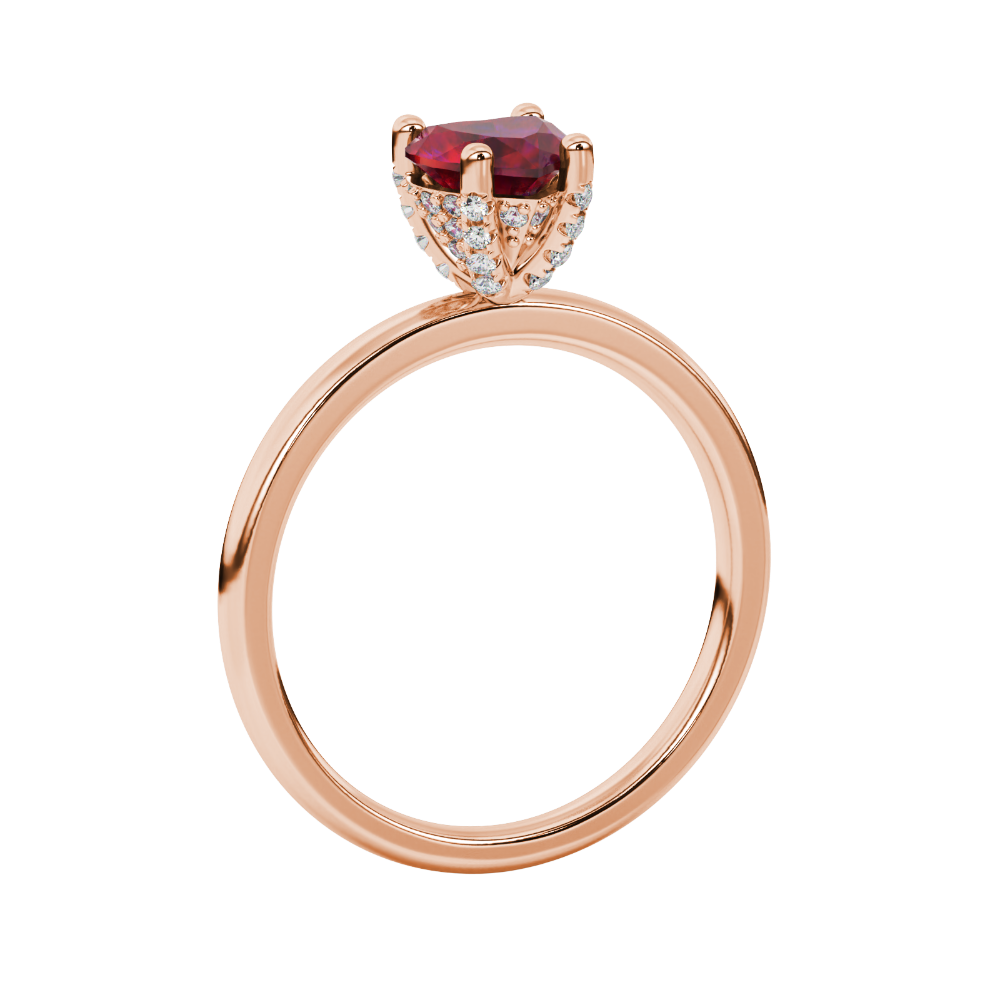 Side view of a rose gold heart gemstone solitaire ring showcasing the hidden diamond pavé basket.