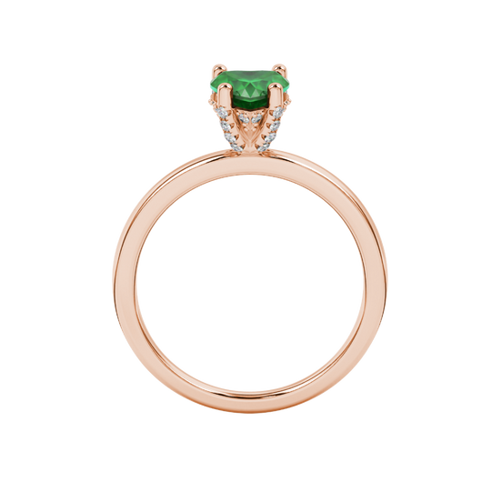 Heart-cut emerald green gemstone solitaire ring in a rose gold
