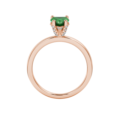 Heart-cut emerald green gemstone solitaire ring in a rose gold