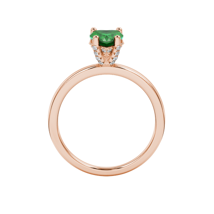 Heart-cut emerald green gemstone solitaire ring in a rose gold