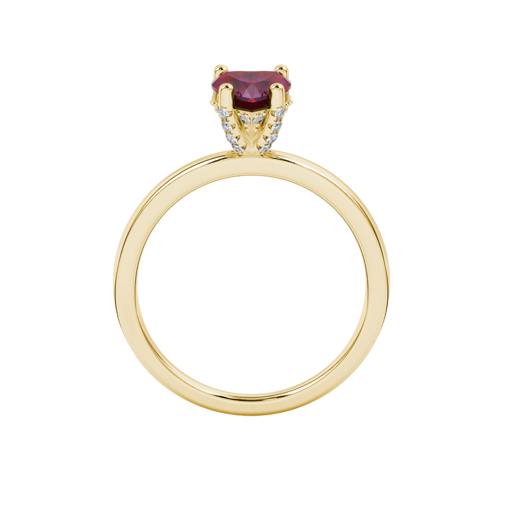 Heart-cut raspberry red gemstone solitaire ring in a yellow gold four-prong setting.