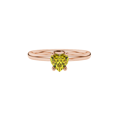 Close-up shot of a heart-shaped canary yellow gemstone with an intricate diamond pavé basket in rose gold.