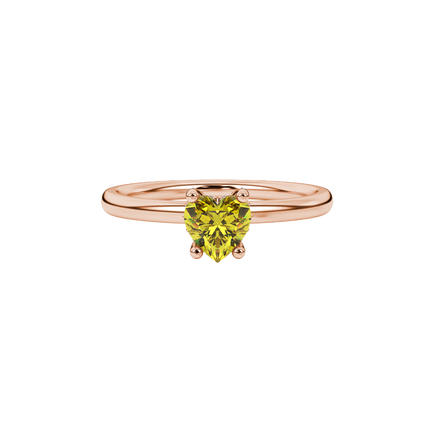 Close-up shot of a heart-shaped canary yellow gemstone with an intricate diamond pavé basket in rose gold.