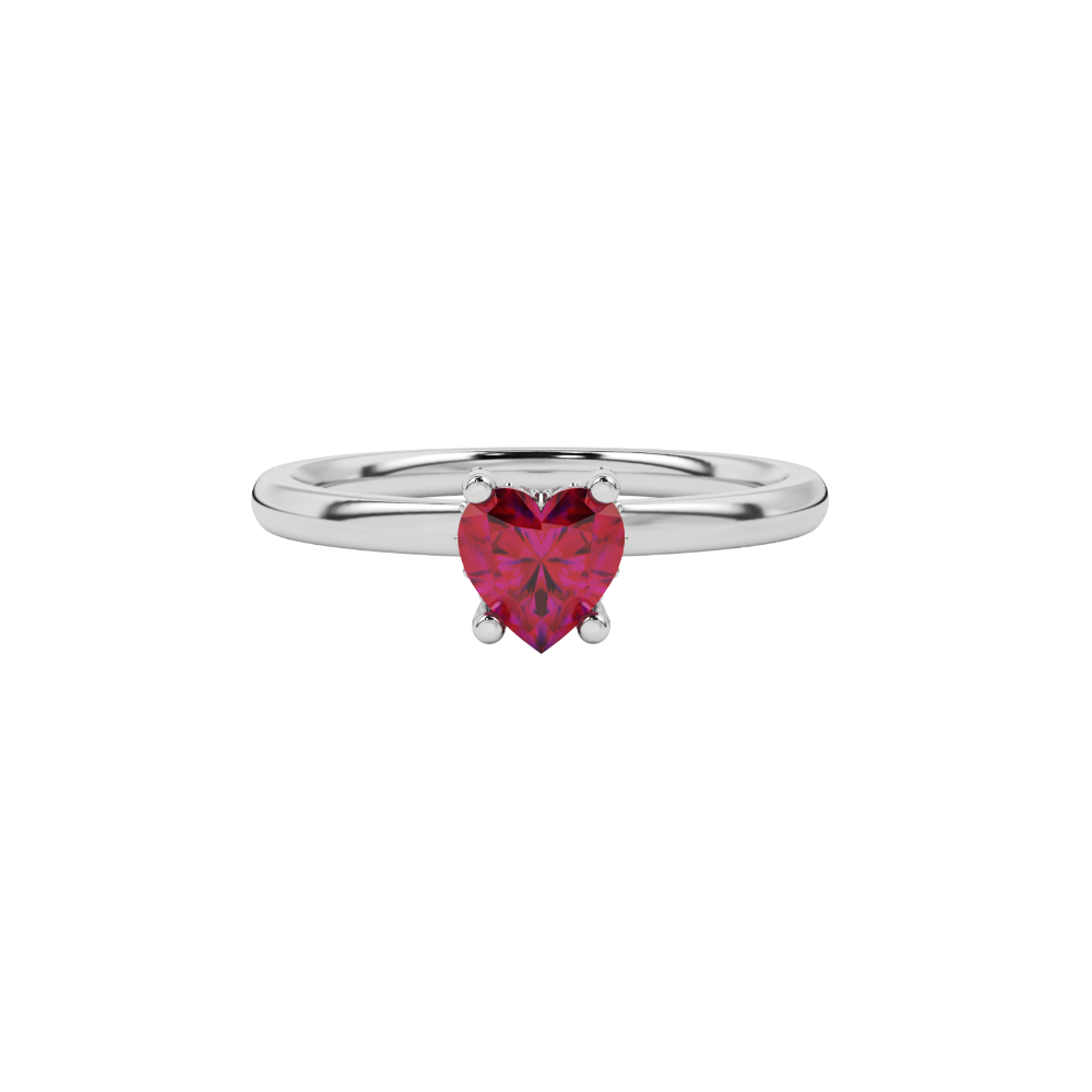 Close-up macro shot of a heart-shaped raspberry red solitaire gemstone in a white gold setting.