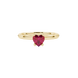 Close-up details of a heart-shaped raspberry red gemstone secured in a yellow gold four-prong setting.
