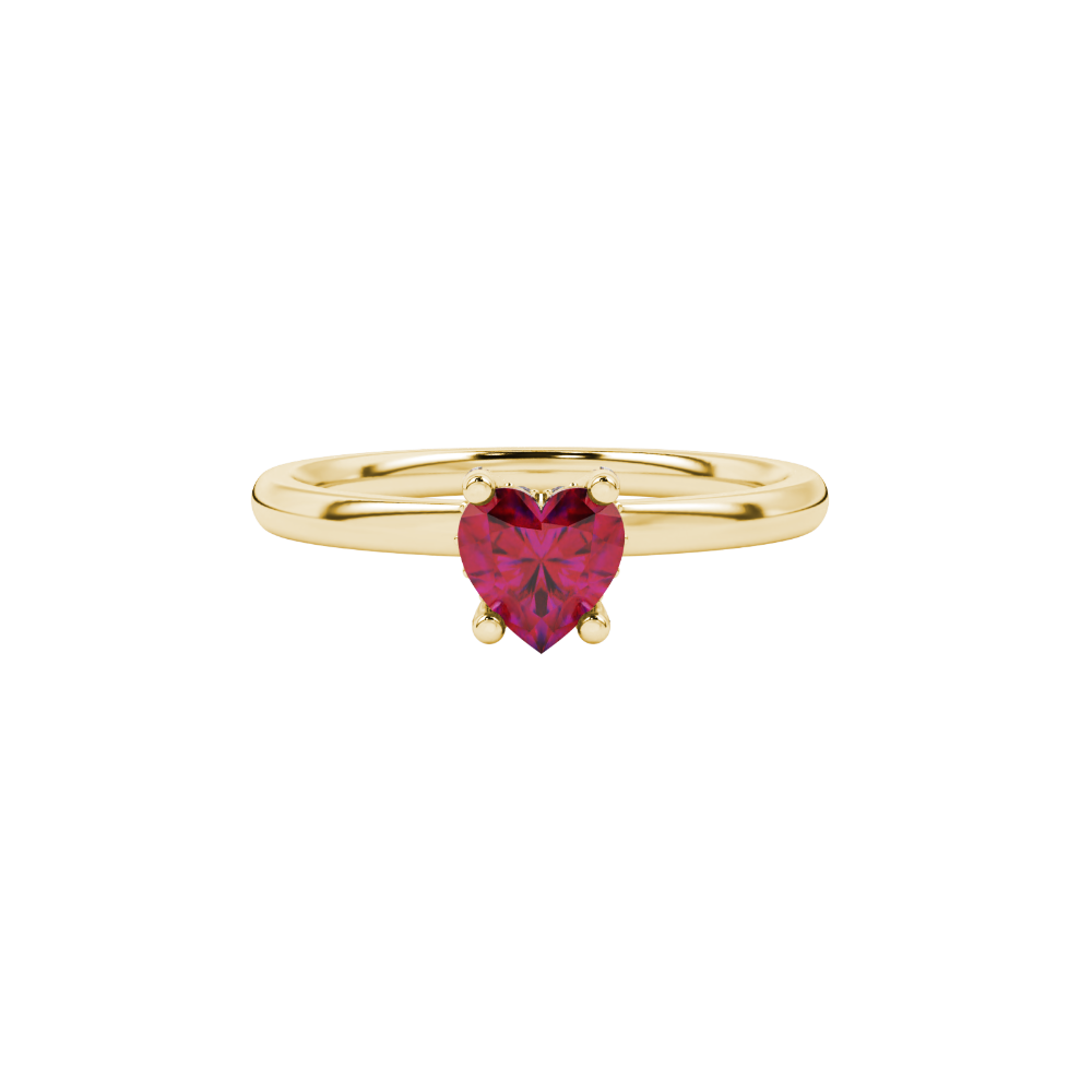 Close-up details of a heart-shaped raspberry red gemstone secured in a yellow gold four-prong setting.