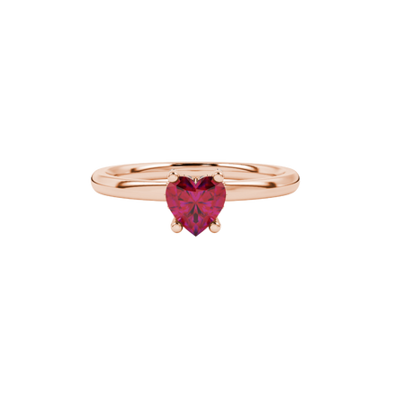 close-up of a heart-shaped raspberry red gemstone with a diamond pavé basket gallery in rose gold.