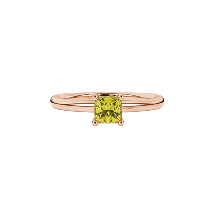 Close-up, princess canary yellow gemstone ring, rose gold four-prong setting.