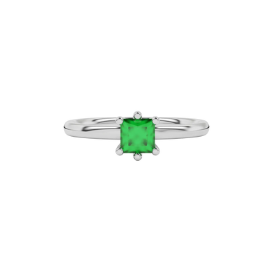 Close-up emerald green gemstone ring, white gold six-prong setting.