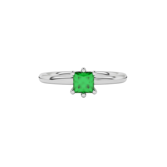Close-up emerald green gemstone ring, white gold six-prong setting.