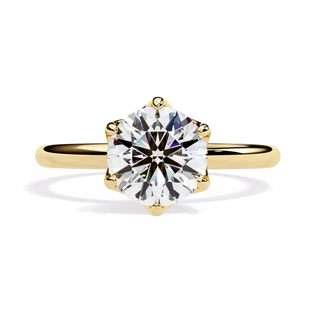 Gold ring with a large diamond on a white background