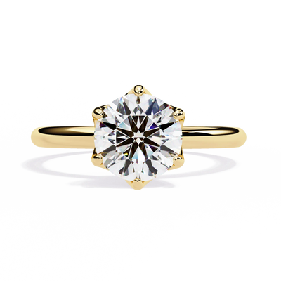 Gold ring with a large diamond on a white background
