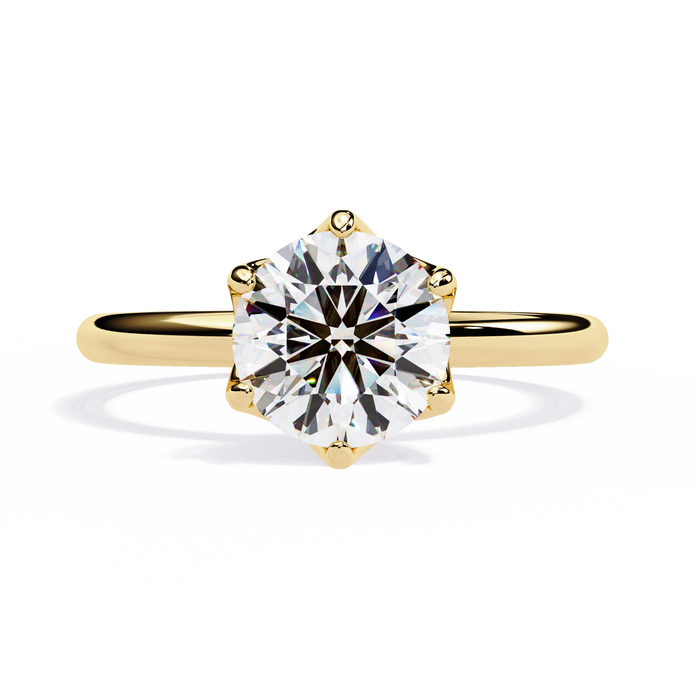 Gold ring with a large diamond on a white background