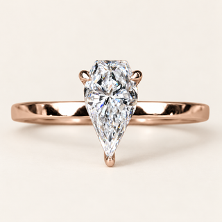 Spear cut lab grown diamond solitaire engagement ring in rose gold with two upper claws, a rounded point prong and a plain band