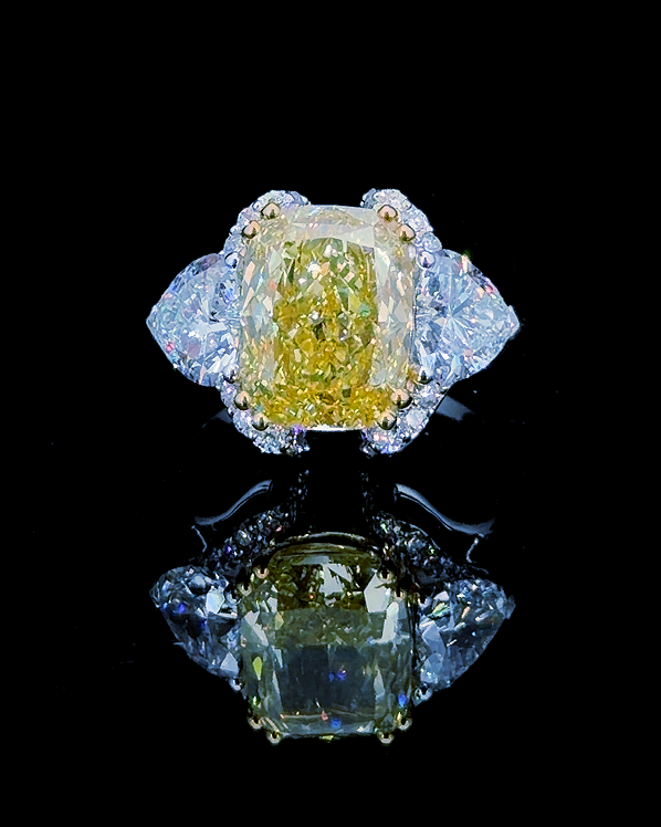 Main: White gold 8.00ct yellow cushion three-stone ring with trillion lab grown diamonds on black
Detail: Close-up of 8.00ct yellow cushion lab grown diamond with trillion sides in white gold
Side: White gold three-stone ring with raised cushion centre and trillion lab grown diamond side profile